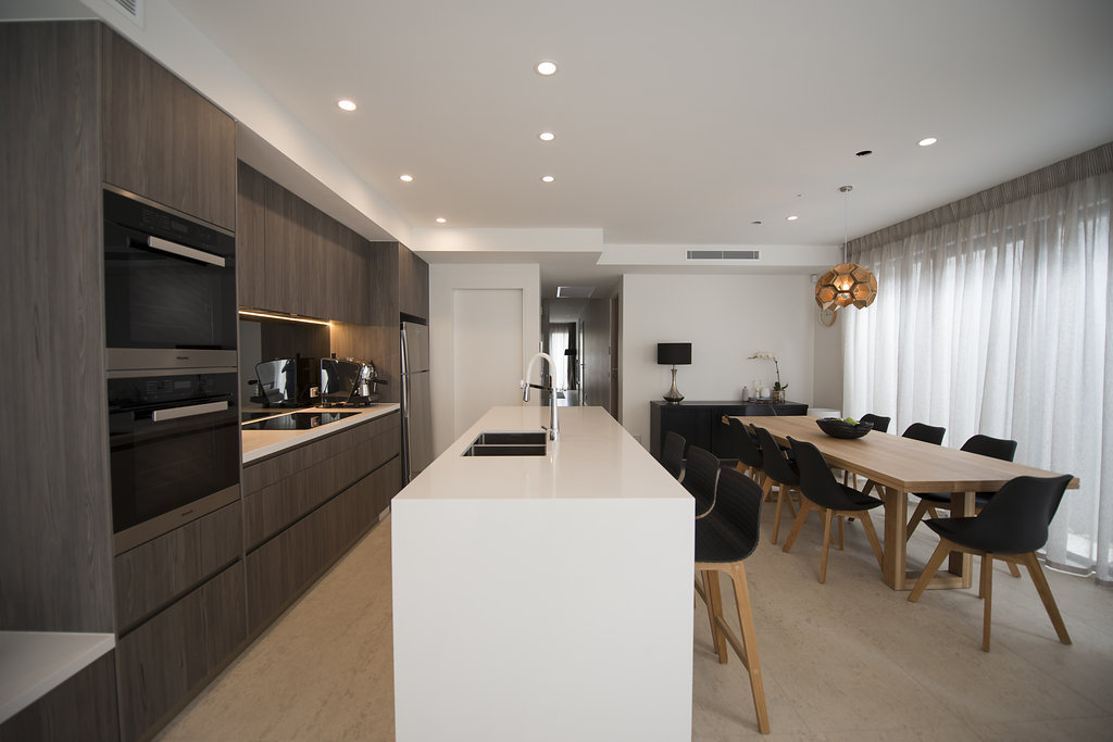 Modern kitchen Melbourne Contemporary kitchen design Melbourne Ceiling lights Feature pendant over dining table Interior joinery and furniture Professional Melbourne designer Professional interior designer Clean line interiors New home designers Brighton New home designers near me Timeless interiors Renovation experts Luxury kitchens Melbourne How to design a kitchen No handles in the kitchen Modern kitchen Brighton Modern kitchen bayside