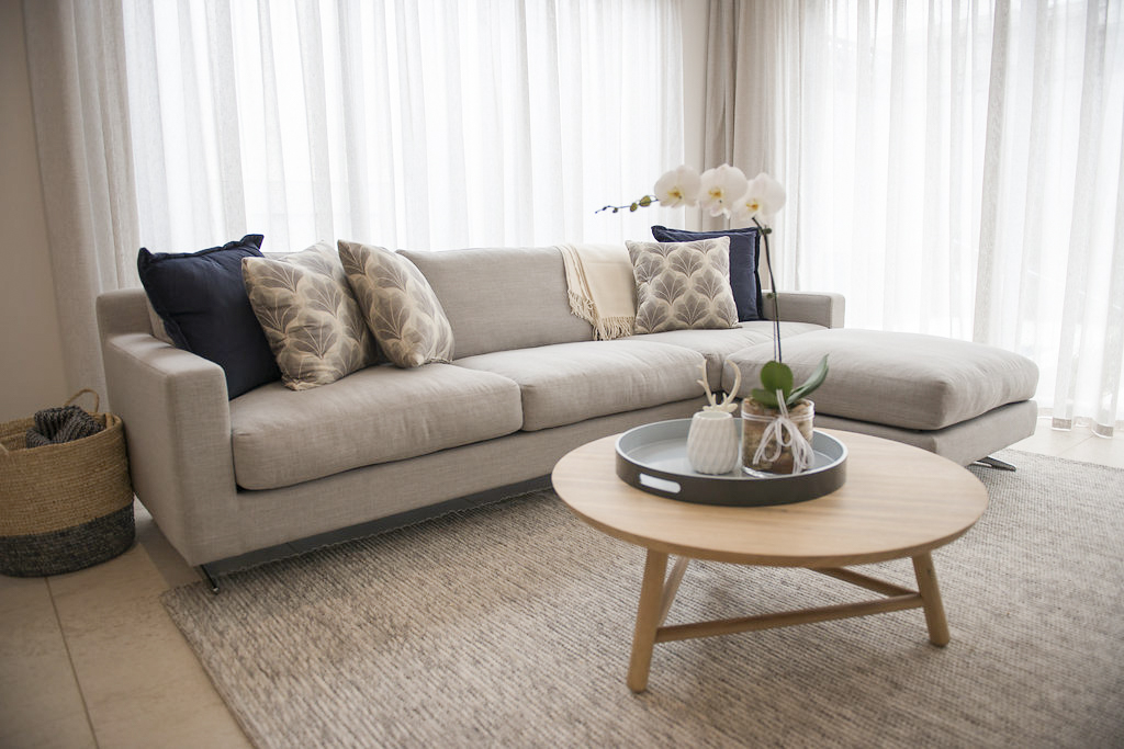 Modular lounge suite Melbourne How big should a rug be Family room spaces Furniture Brighton How to get a designer look in my family room Brighton interior design consultant Styling coffee tables Custom made design Modular sofa Your beautiful home Hampton interior design Hampton interiors Wooden tray Painted tray