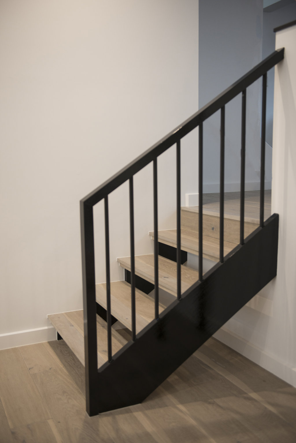 Black staircase Timber treads Black hand rail