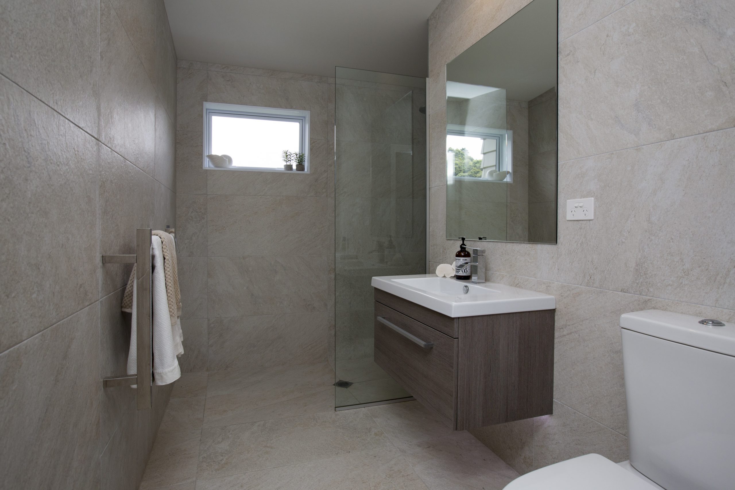 Light-filled coastal bathroom with soft neutral tones at Sorrento Beach House by Natasha Walker Interiors, Melbourne